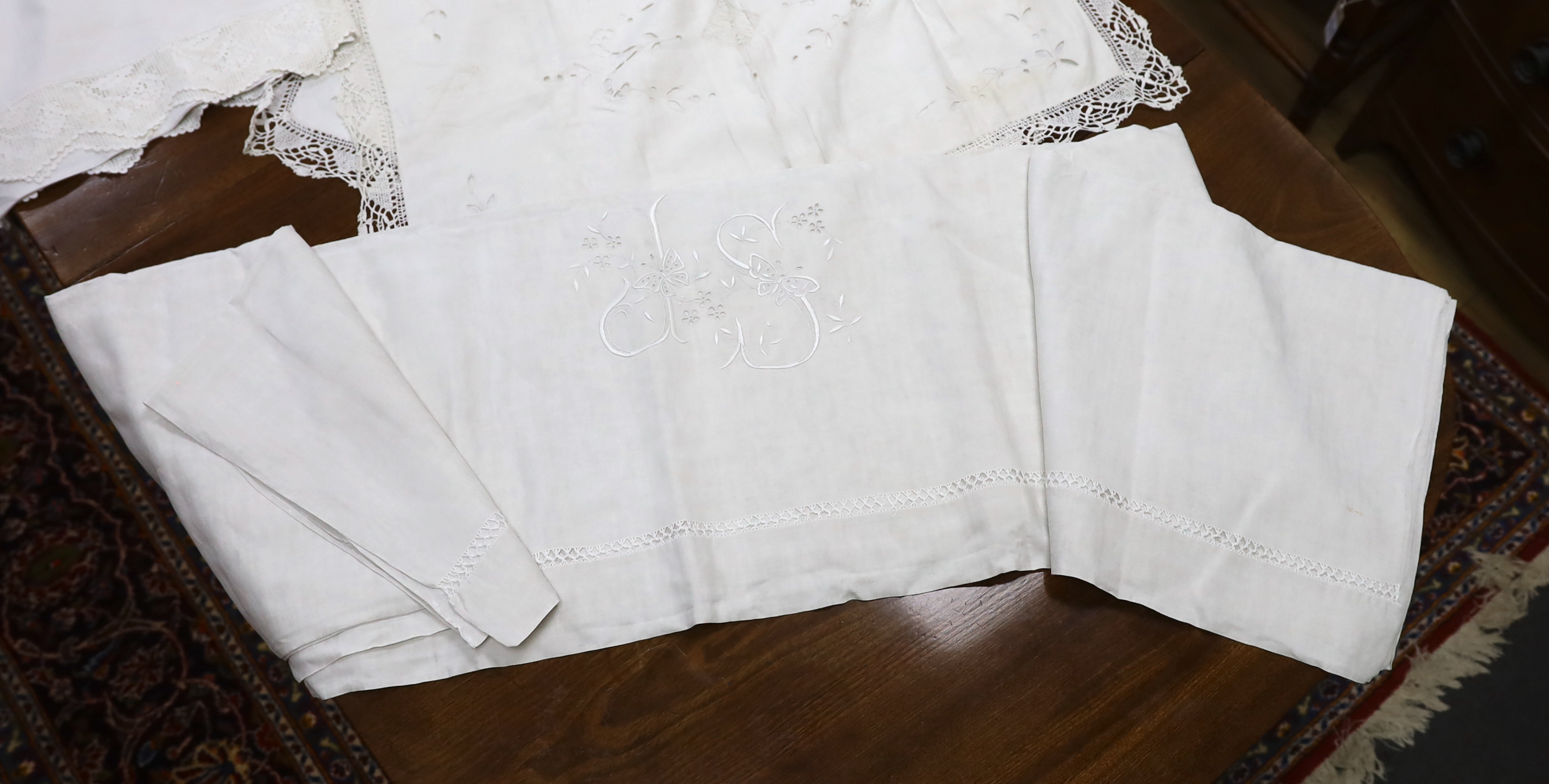 19th-20th century bed linen; a monogrammed sheet, 7ft 6in., and a smaller crochet edged sheet, a pair of French square Anglaise pillow cases, three similar appliqué pillow cases, a frilled single square pillow case and a